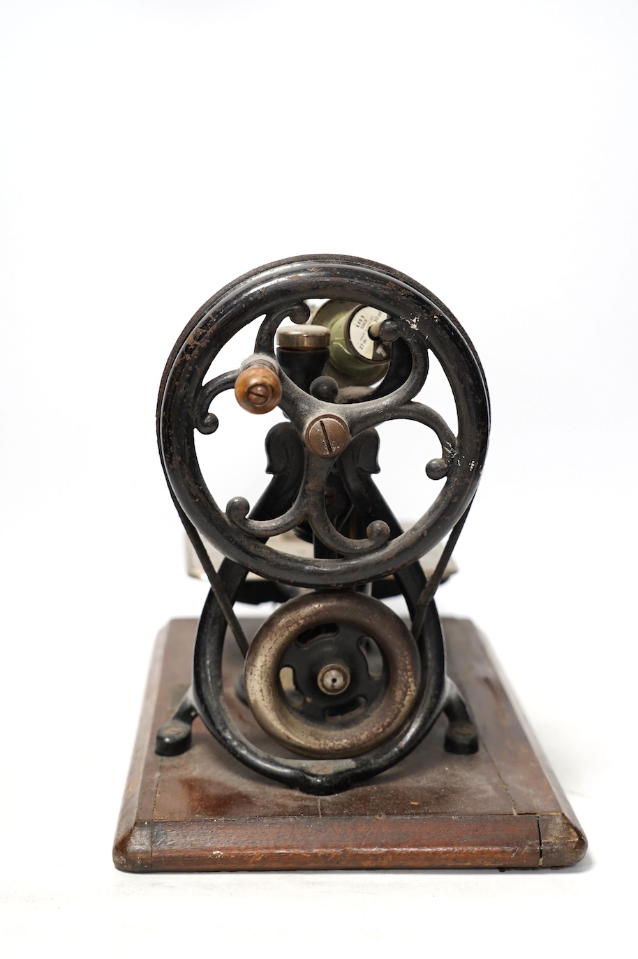 A late 19th century Wilcox and Gibbs sewing machine on a mahogany base. Condition - fair